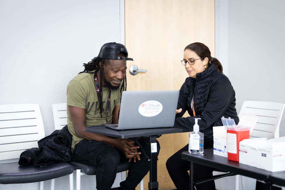 Angela Potes Duran, an MPH student, discusses test results with a laundromat patron at a recent pop-up clinic in San Antonio.